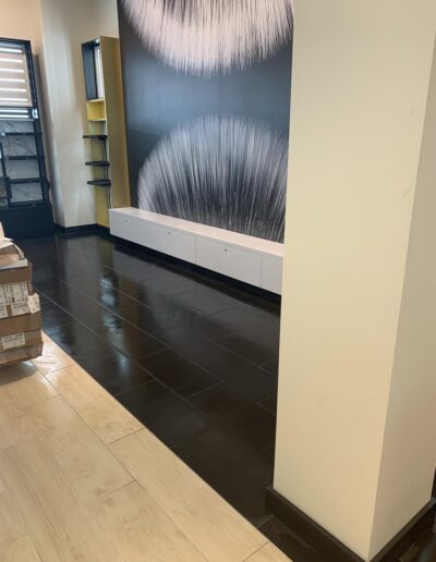 Clean office lobby with light wood floors and abstract wall art, cleaned by Two Sisters Maid To Clean, commercial cleaning services.