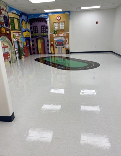 Shiny clean tile floor is a children's play room, cleaned by Two Sisters Maid To Clean, commercial cleaning services.