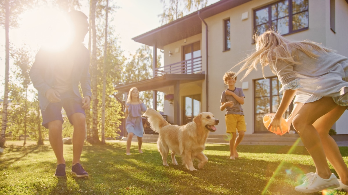 Family enjoying a clean home and yard with their dog after professional maid service.