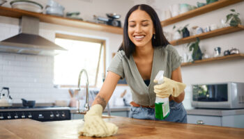 woman cleaning kitchen counters